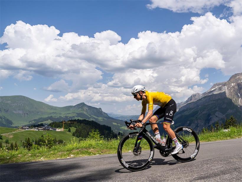 Tadej Pogacar führt bei der Tour de France, fährt dynamisch im Renntrikot auf der Straße