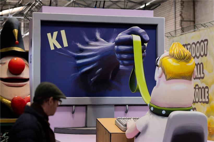 Arbeitnehmer mit Leine symbolisch gefesselt, Kölner Karneval thematisiert KI-Auswirkungen auf Arbeitswelt