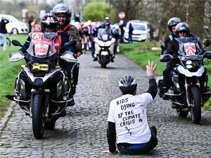 Gefährliche Protestaktion während der Tour of Bruges Radrennen auf der Straße mit Zuschauern im Hintergrund