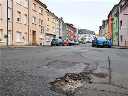 Straße mit Schlaglöchern, die alle vier bis fünf Wochen von Einwohnern regelmäßig ausgebessert werden