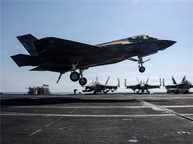 F-35C Lightning II Kampfjet bei der Landung auf Flugdeck eines Flugzeugträgers unter klarem Himmel