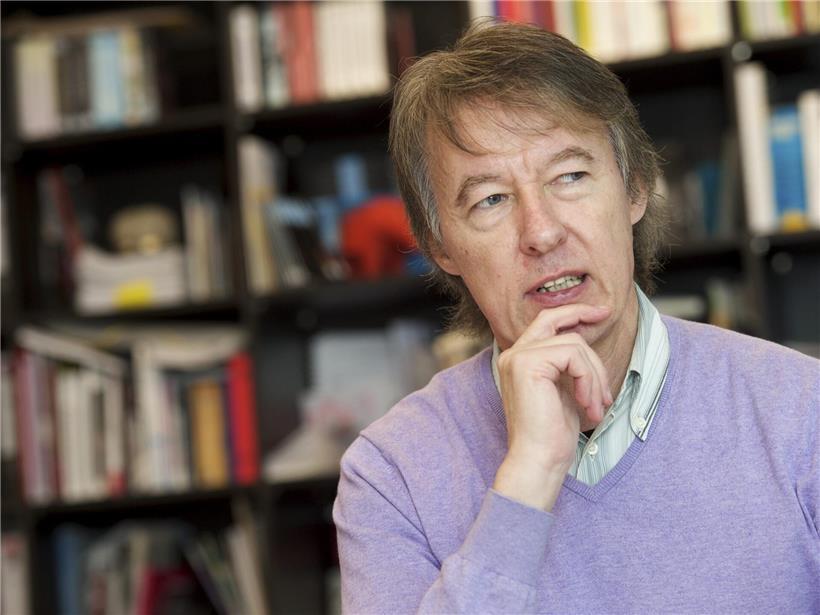 Porträt von Frank Hoffmann, deutscher Schauspieler, lächelnd vor neutralem Hintergrund